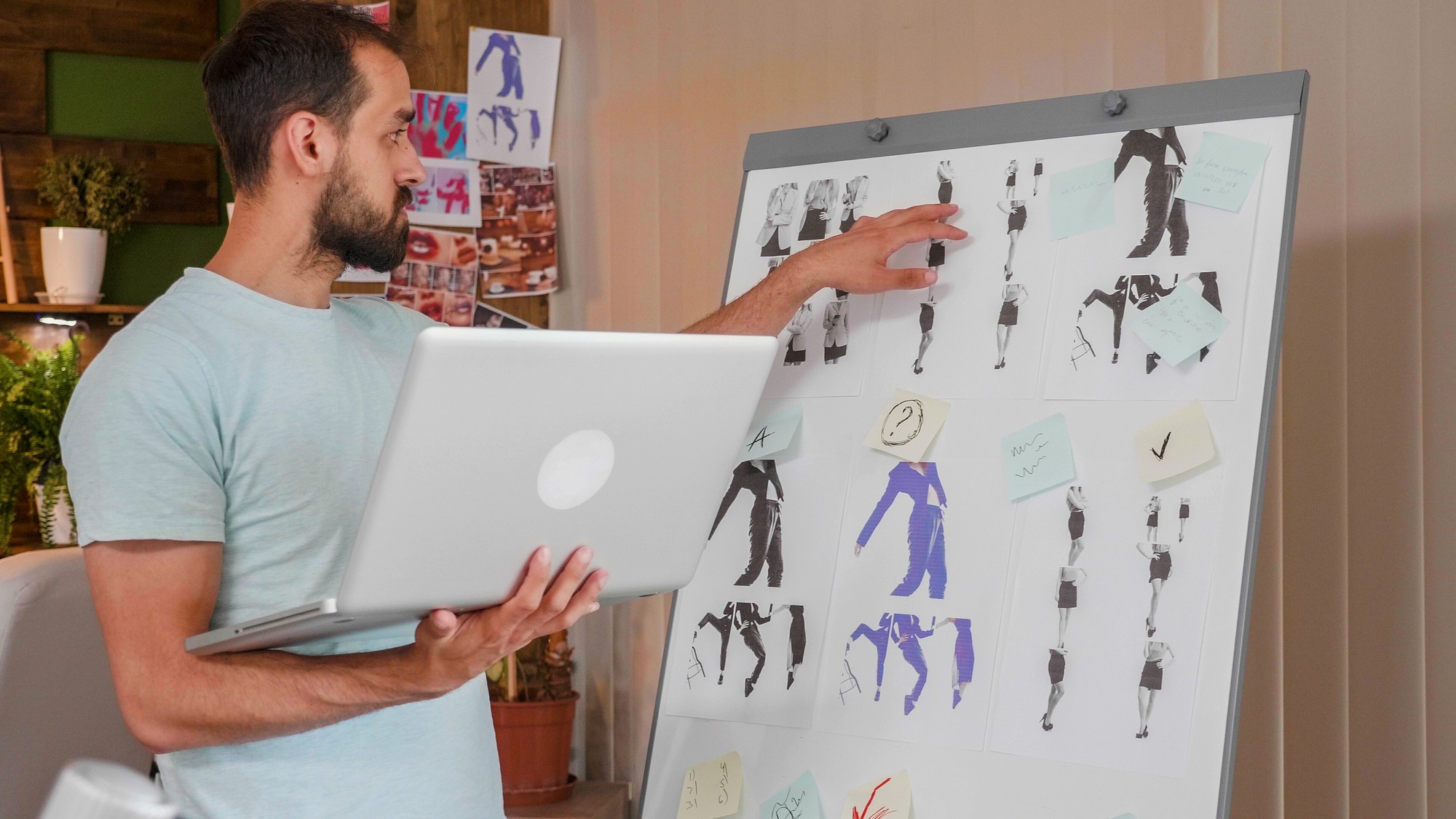 young-designer-working-whiteboard-holding-laptop-creativ-agency_482257-26451